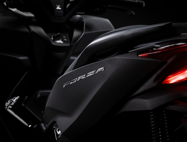 Close-up of a black scooter featuring the word Forza and a visible rear light.