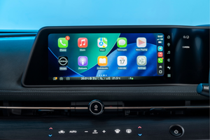 Car dashboard with a touchscreen display showing various app icons.