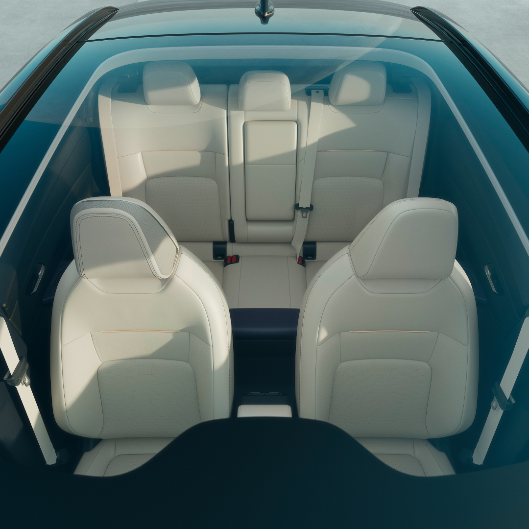 Car interior with cream leather seats viewed from above.