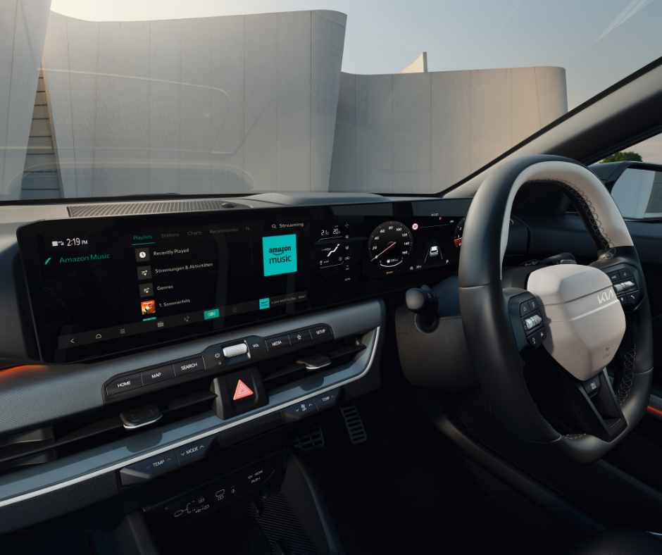 Car interior showing dashboard display with Amazon Music app open.