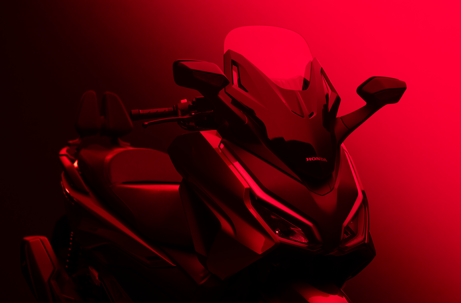 Close-up of a red motorcycle angled front view, highlighting the design and details.