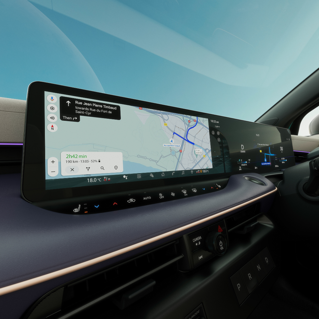 Car dashboard display showing navigation map and controls.