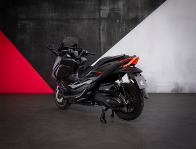 Black scooter on display with rear view.