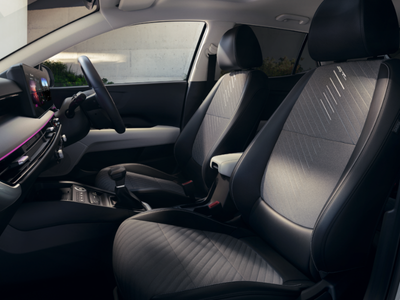 Front seats and dashboard view of a car interior with black upholstery.