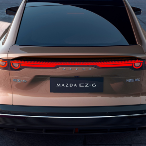 Rear view of a Mazda EZ-6 vehicle showing taillights and model badge.