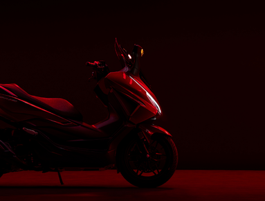 Side profile of a red-lit scooter in partial darkness.