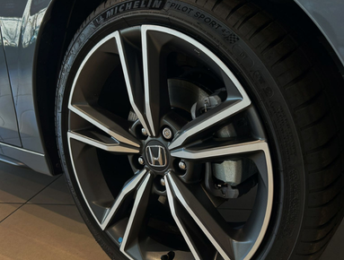 Close-up of a car's alloy wheel with a Michelin tyre and Honda logo.