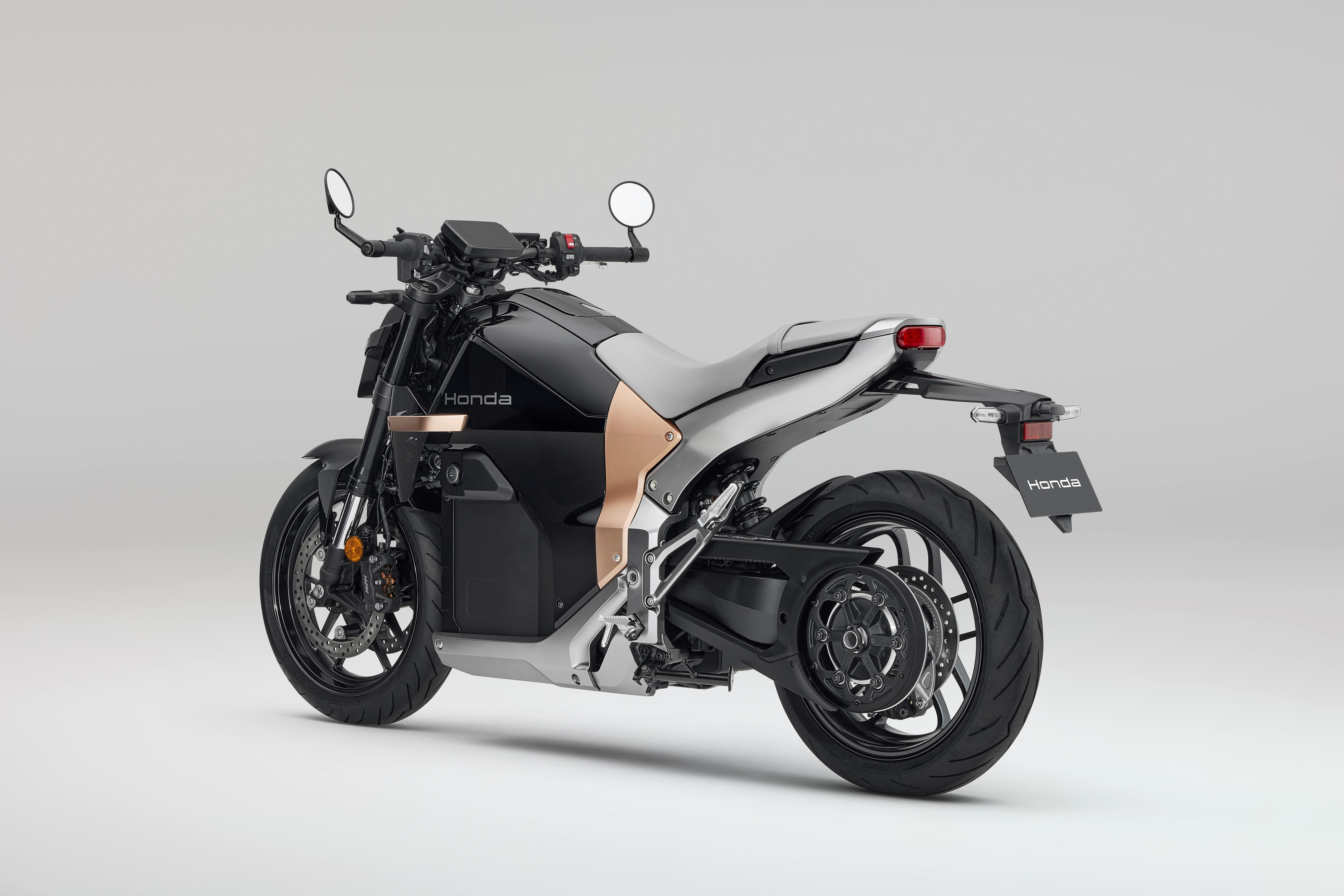 Black and silver Honda motorcycle, side view, showcasing modern design.