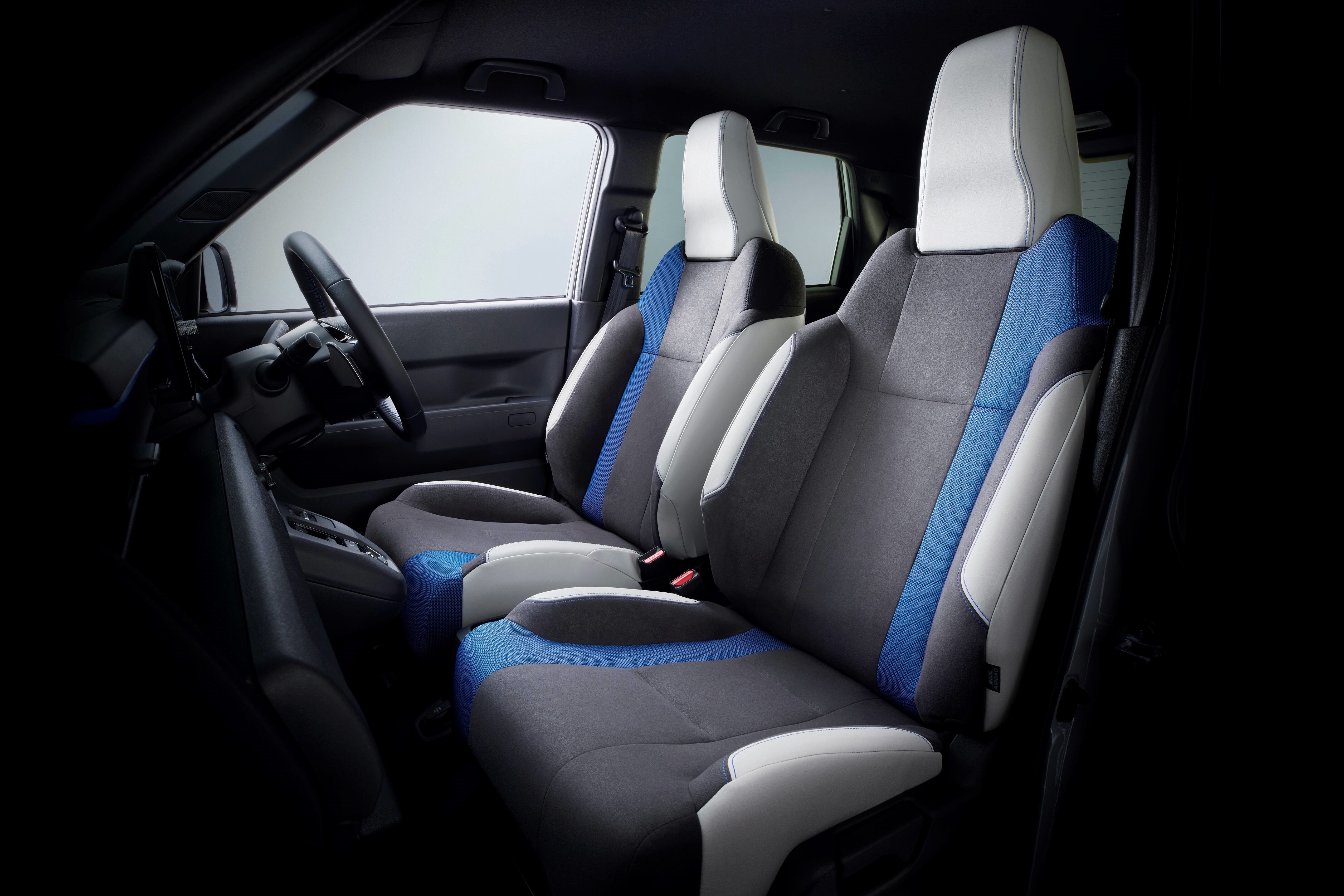 Front seats of a car with blue and grey upholstery.