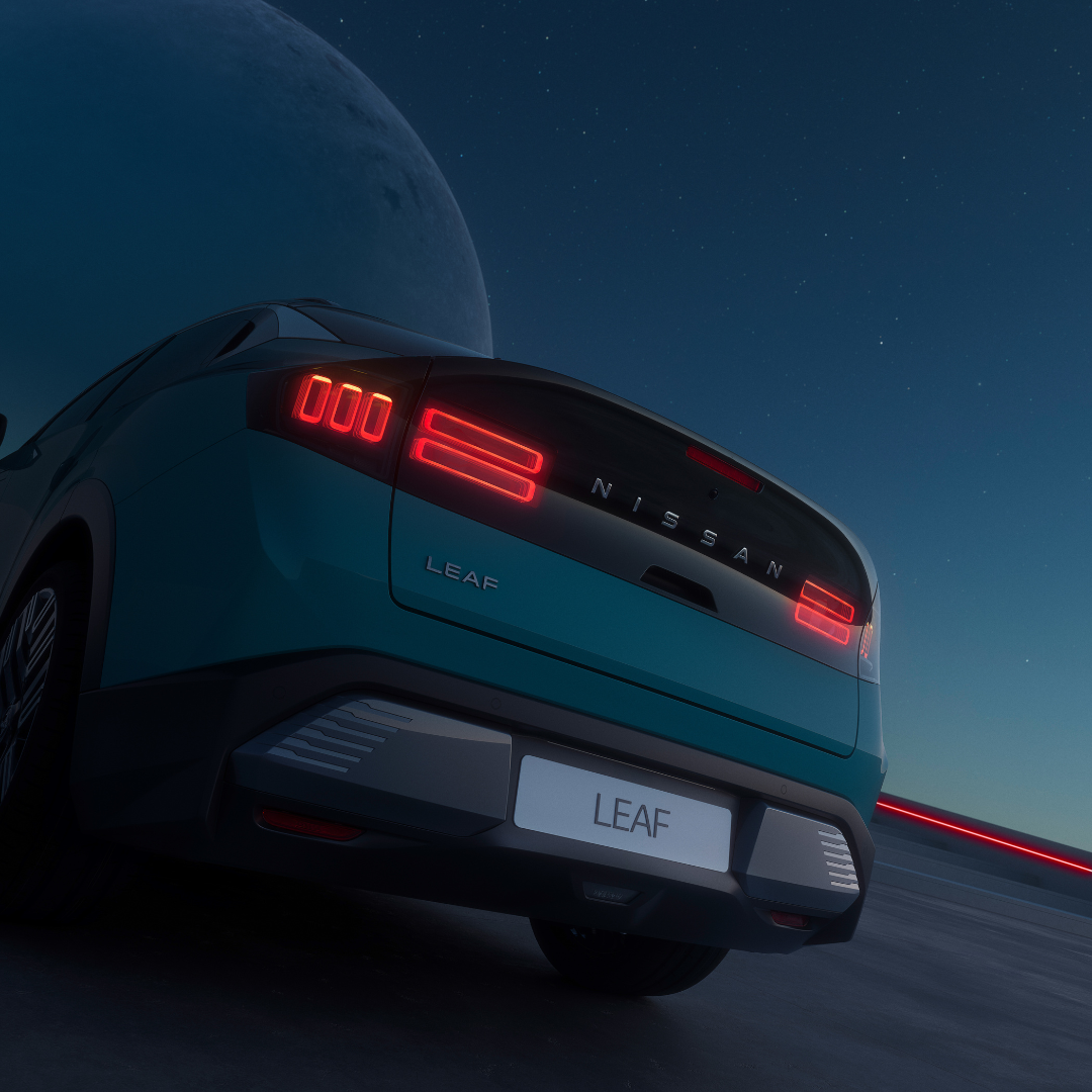 Nissan Leaf electric car rear view with illuminated tail lights.