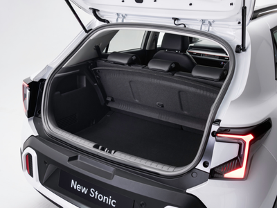Car boot open with rear seats visible, showing interior of a white vehicle.