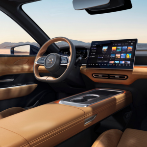 Modern car interior with tan leather seats and a large digital display screen.