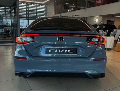 Rear view of a grey Honda Civic car displayed indoors.