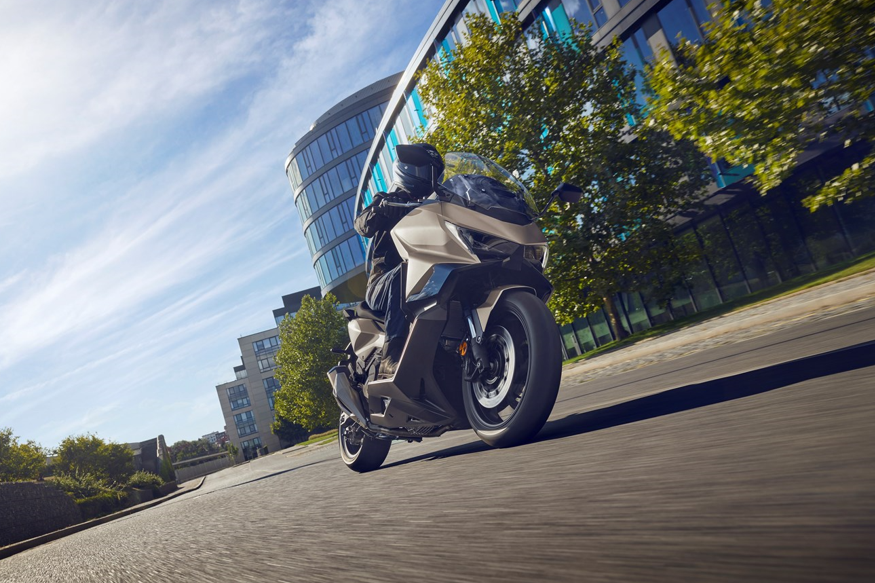 Rider on a modern motorbike traveling on an urban road.
