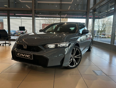 Grey Honda Civic displayed indoors with showroom lighting.