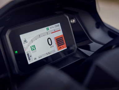 Motorbike digital display showing speedometer, gear indicator, and more at 0 km/h in neutral.