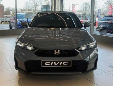 Front view of a grey Honda Civic car in a showroom.