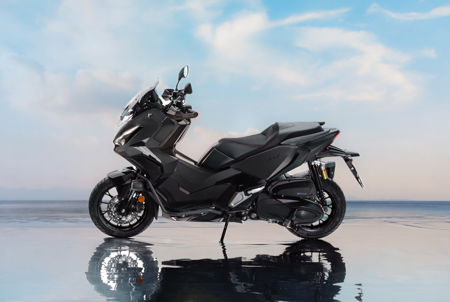 A black scooter with a sleek design, viewed from the right side.