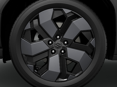 Close-up of a car wheel with a geometric black and grey alloy design.
