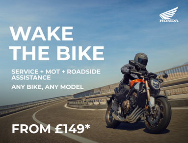 Motorbike rider on a road with Honda branding and service details in text.