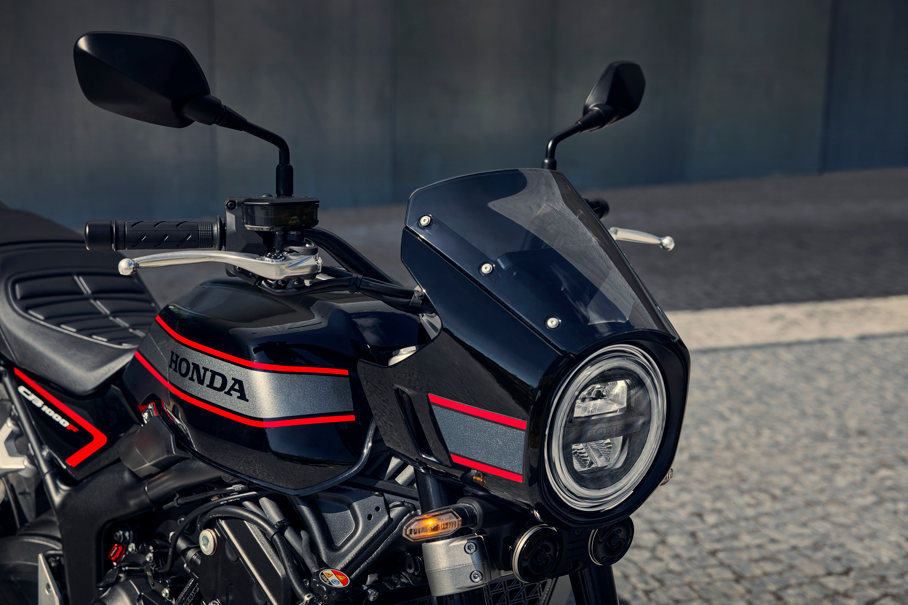 Close-up of a Honda motorcycle's front view showing headlight and handlebars.