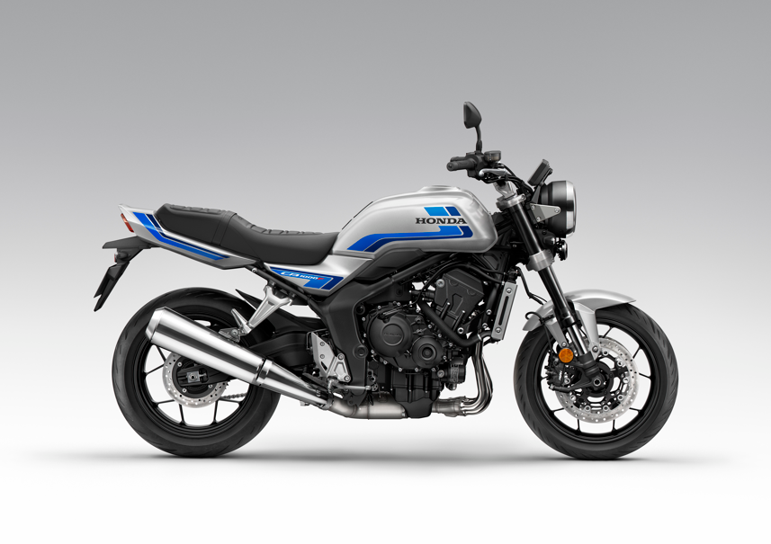 Silver and blue Honda motorcycle, side view showing engine and exhaust details.