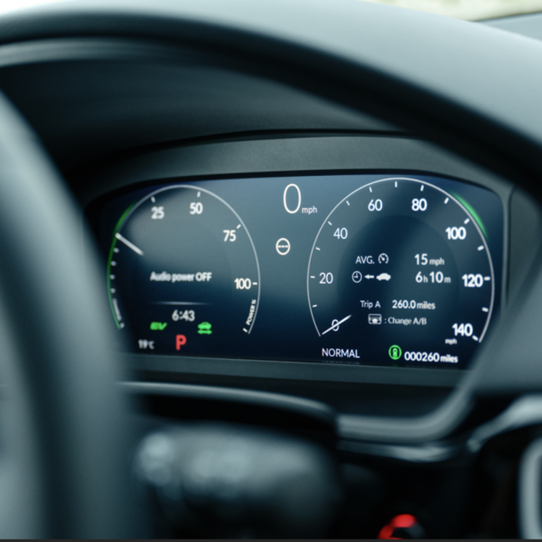 Close-up of a car dashboard displaying speedometer and various driving information.