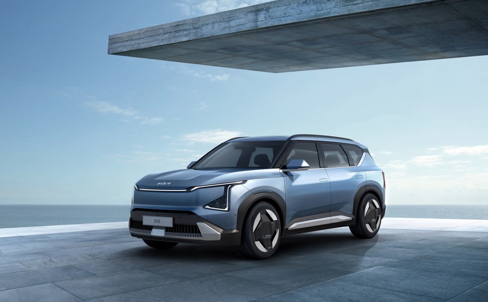 A blue SUV parked on a terrace by the sea.