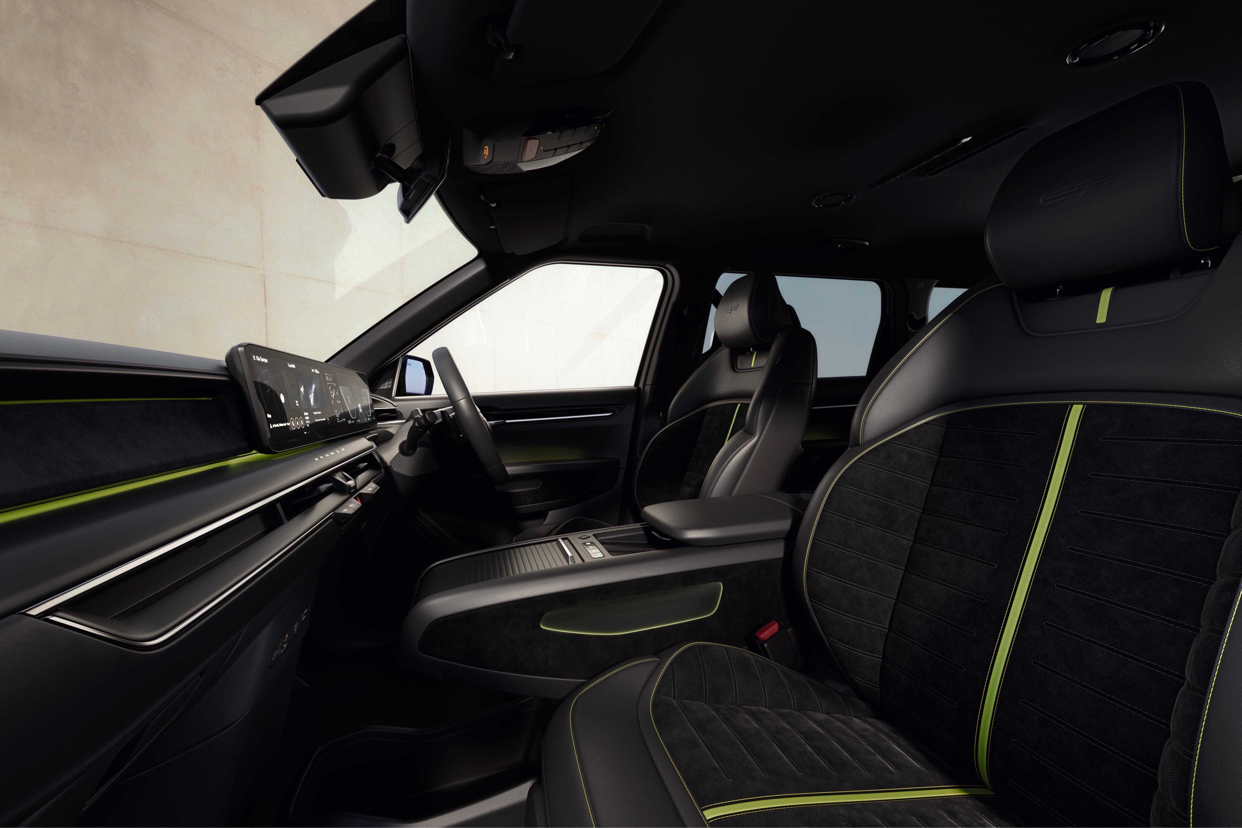 Interior of a car showing black and green seats and dashboard display screen.