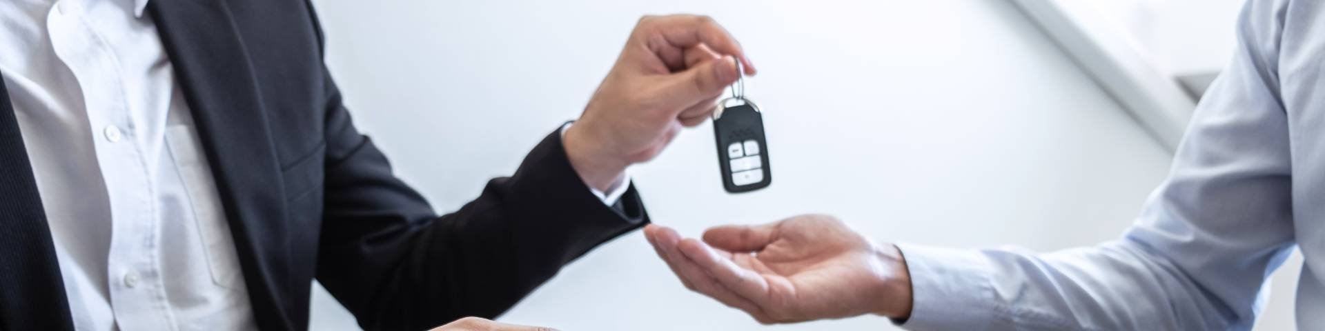 Woman handing man car keys