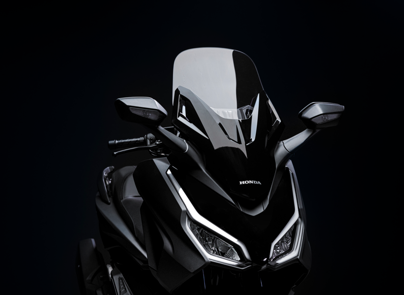 Close-up of a black Honda motorcycle with a clear windscreen.