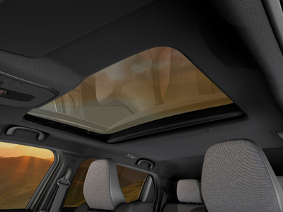 Car interior with a panoramic sunroof and grey fabric seats.