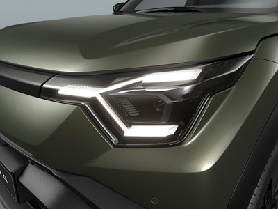 Close-up of a car's front headlight with a sleek design.