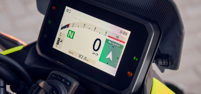 Motorbike digital dashboard showing speed, gear, trip meter, and navigation.