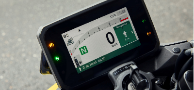 Motorcycle digital dashboard showing speed at 0 km/h and navigation instructions.