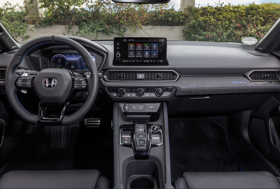 Interior view of a car dashboard showing a steering wheel and infotainment system.