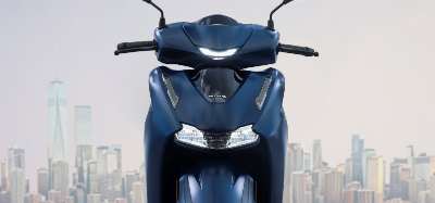 Blue Scooter zoomed in on headlights front facing