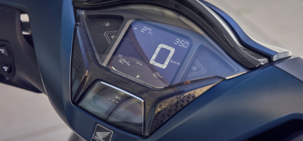 Digital dashboard of a Honda motorbike showing speed, temperature, and time.