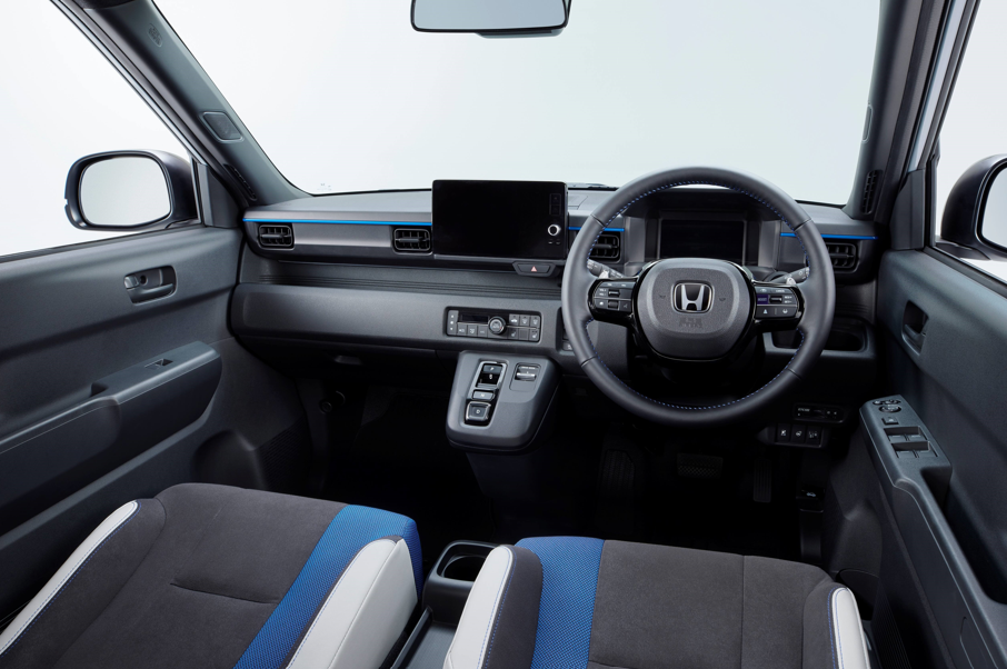 Interior view of a Honda car showing the steering wheel and dashboard.