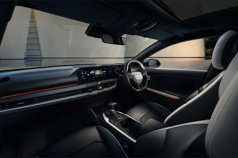 Interior of a car showing the dashboard, steering wheel, and front seats.