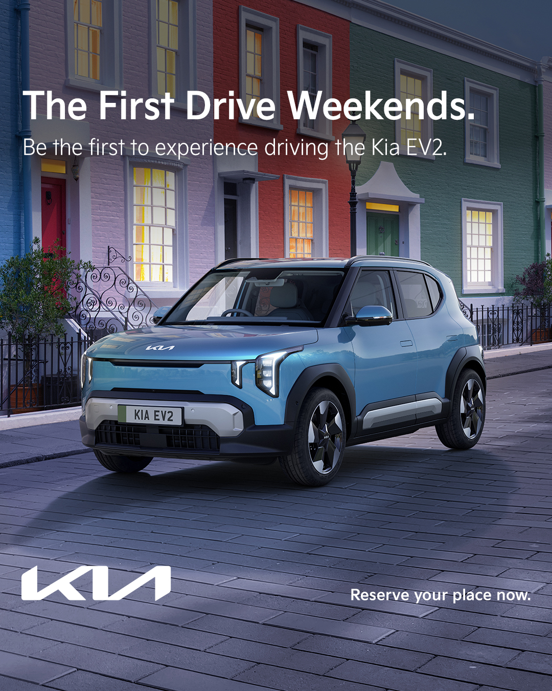 Blue Kia EV2 car parked on a street with colourful houses, text promoting First Drive Weekends.