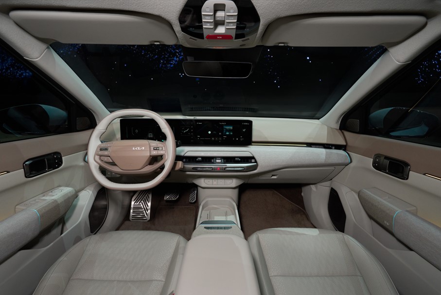 Interior of a car showing dashboard, steering wheel, and digital displays.
