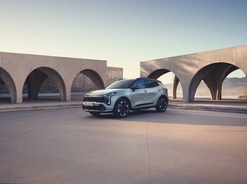 Silver SUV parked near concrete arches.
