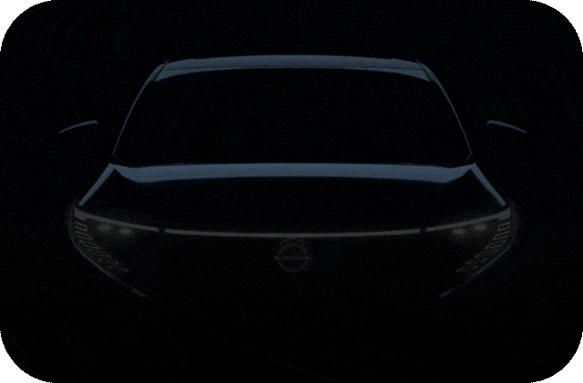 Front view silhouette of a modern SUV with illuminated headlights.