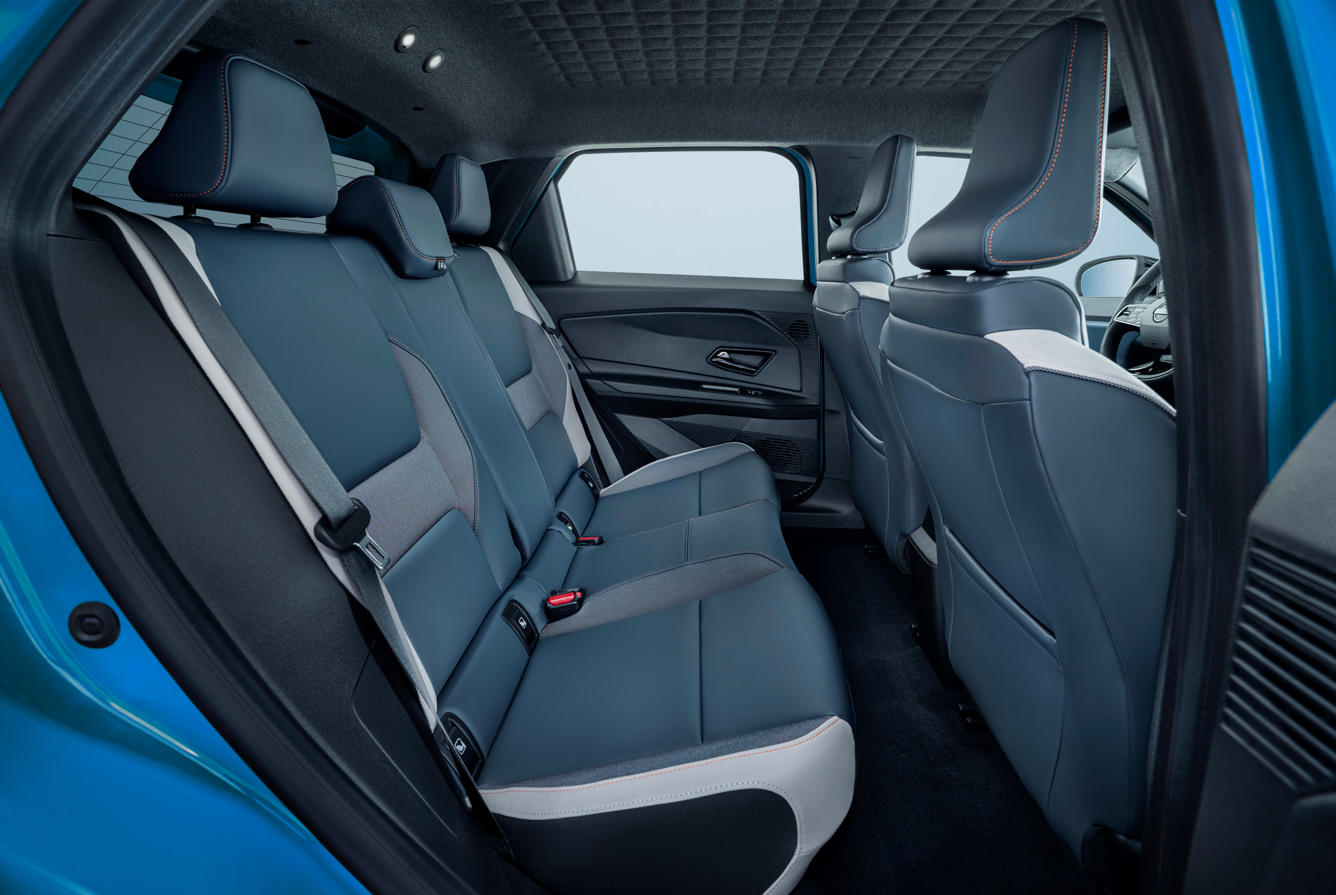 Interior of a car showing rear seats in dark blue upholstery.
