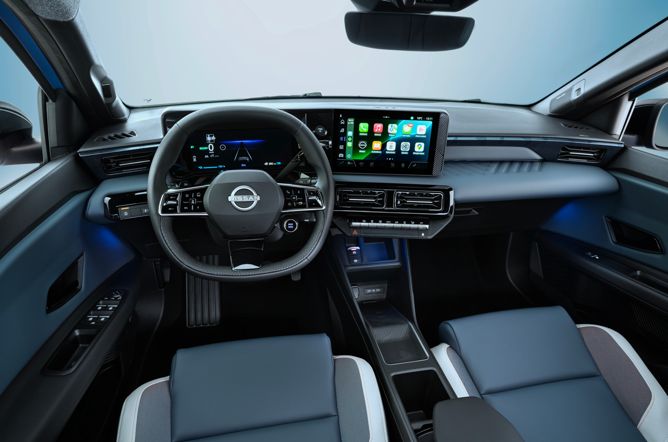Car interior with steering wheel, digital dashboard, and touchscreen display.