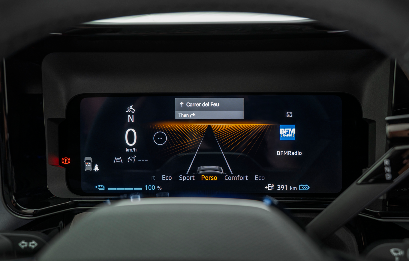 Close-up of a car digital dashboard showing navigation and radio display.