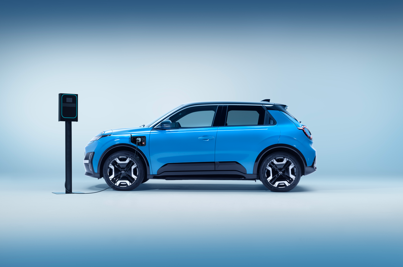 Blue electric car charging at a charging point.