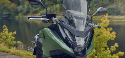 Green Honda NC750X zoomed in on front headlight and windshield
