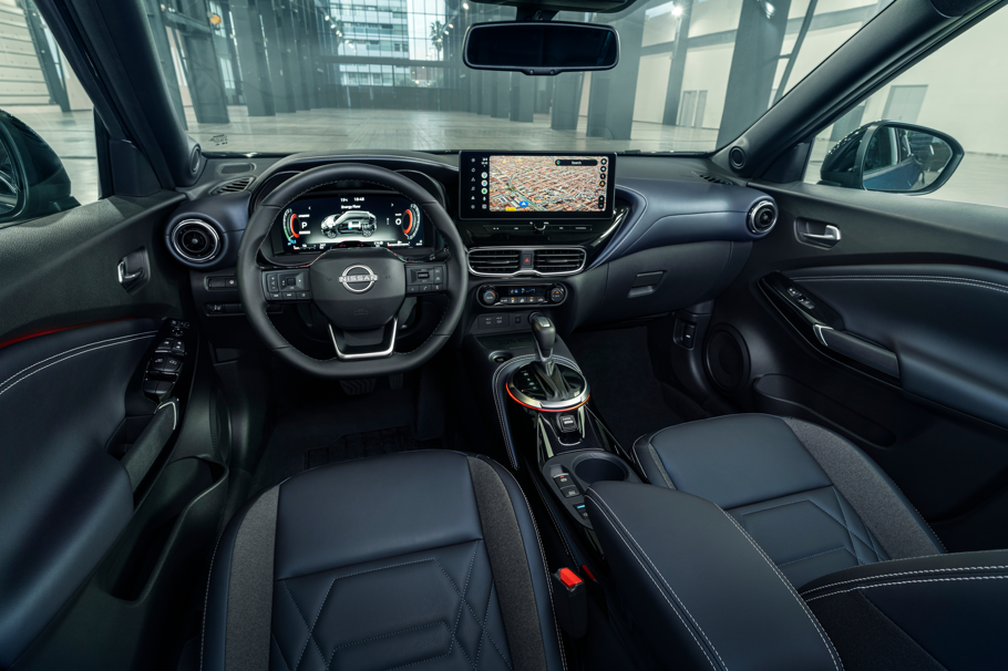 Interior view of a car showcasing steering wheel, dashboard, and touchscreen display.